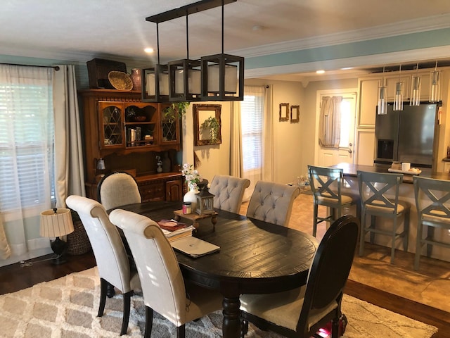 dining room featuring ornamental molding and wood finished floors