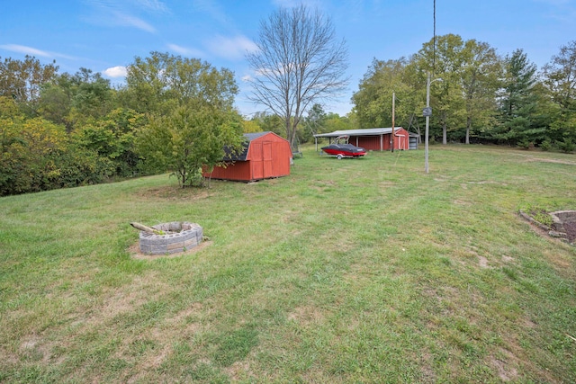 view of yard with a storage unit and a fire pit