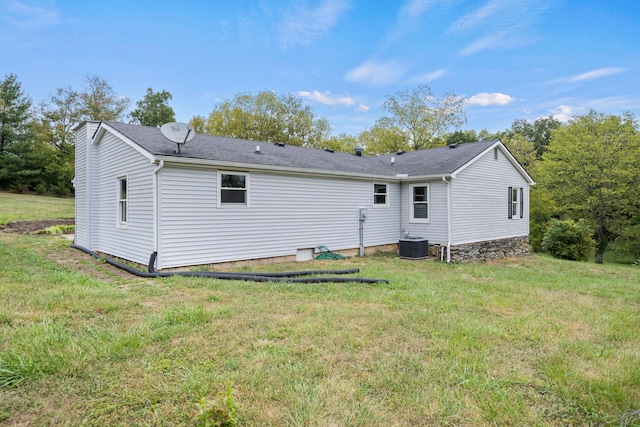 back of house with a yard and central air condition unit