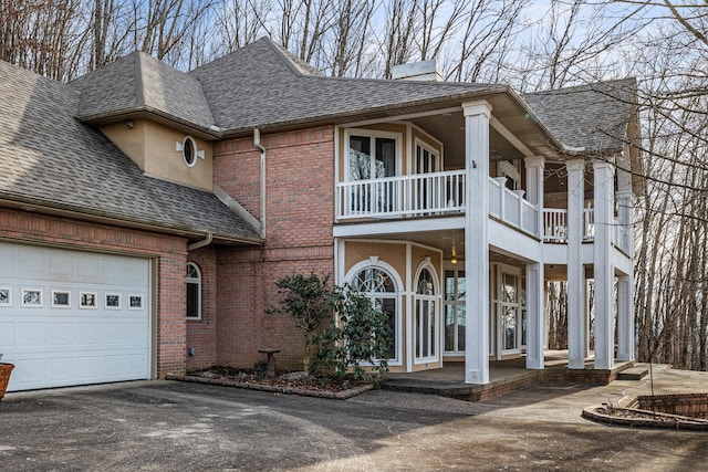 view of front of property with a balcony and a garage