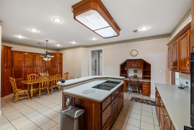 kitchen with cooktop, light tile patterned flooring, a kitchen island, and decorative light fixtures