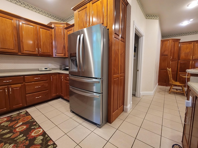 kitchen with stainless steel refrigerator with ice dispenser and light tile patterned floors