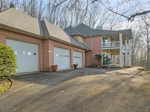 view of front of property with a balcony, a garage, and a porch