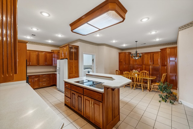 kitchen featuring light tile patterned flooring, white fridge with ice dispenser, stainless steel stovetop, decorative light fixtures, and a kitchen island with sink