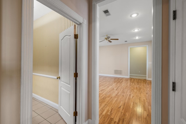 hallway with light hardwood / wood-style floors