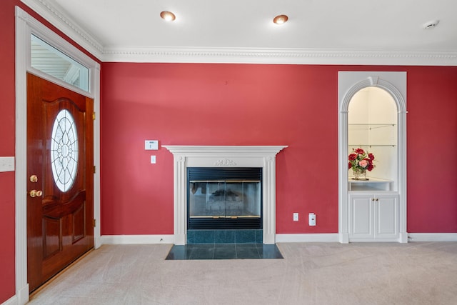 carpeted foyer entrance with crown molding