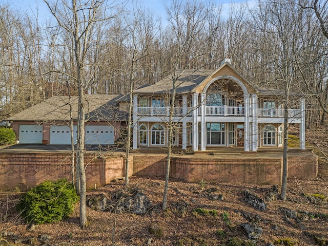 view of front of home featuring a balcony and a garage