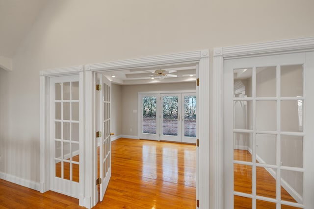 hall featuring light hardwood / wood-style floors, french doors, and ornate columns