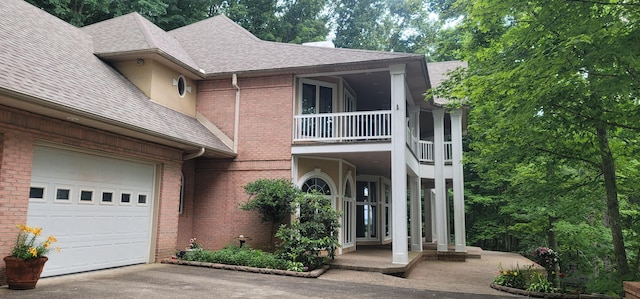 view of front of house featuring a balcony and a garage