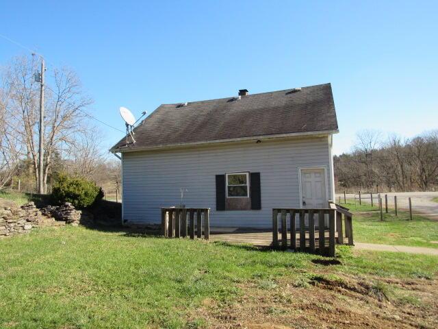 view of property exterior with a yard