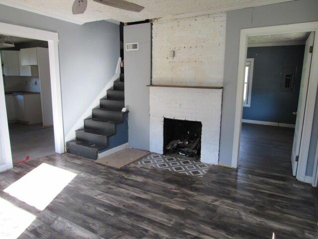 living room featuring dark hardwood / wood-style floors, a fireplace, and a textured ceiling