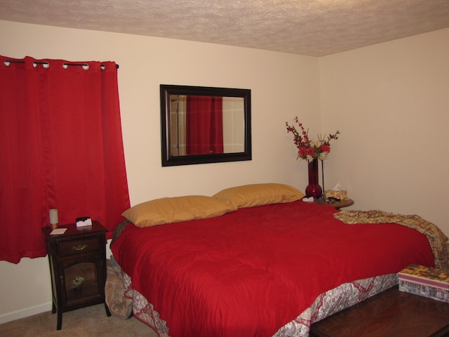 carpeted bedroom with a textured ceiling