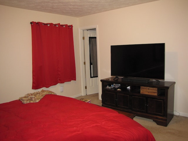 carpeted bedroom featuring a textured ceiling