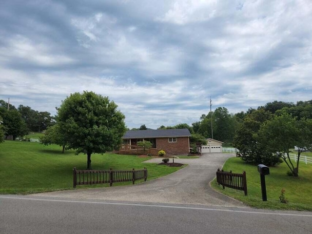 single story home featuring a garage and a front yard