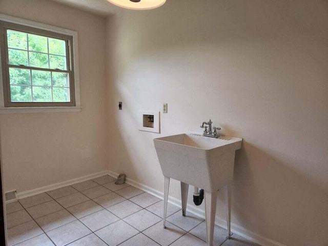 clothes washing area with washer hookup, electric dryer hookup, and light tile patterned floors