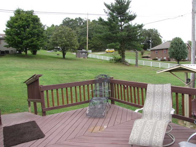 wooden deck featuring a lawn