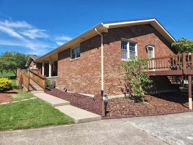 view of side of property with a wooden deck