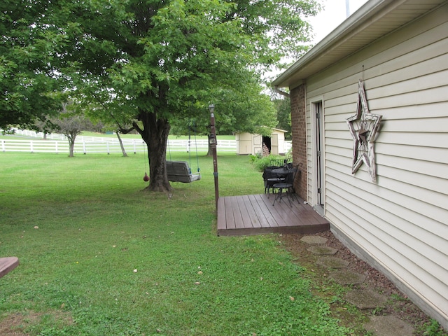 view of yard with a deck and a shed