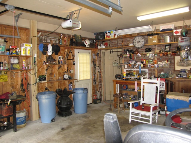 garage featuring a garage door opener and a workshop area