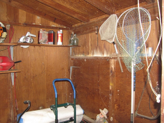 interior details with wood ceiling, beam ceiling, and wood walls