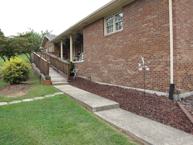 view of property exterior featuring a yard and covered porch