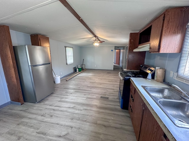 kitchen featuring appliances with stainless steel finishes, light hardwood / wood-style floors, ceiling fan, and plenty of natural light