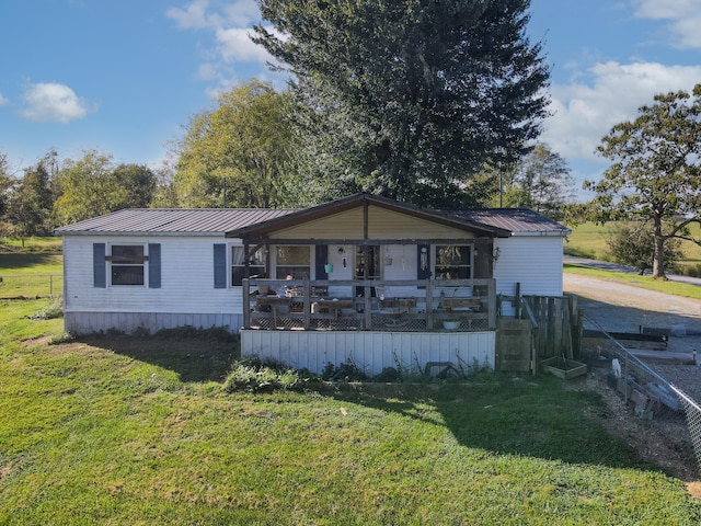 view of front of property with a deck and a front yard