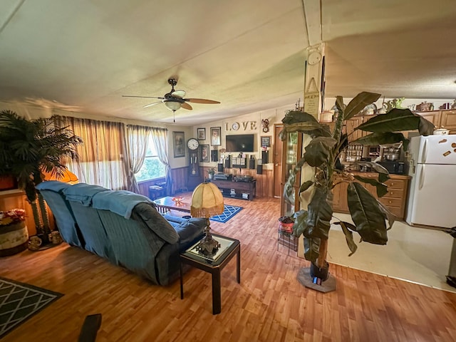 living room with light hardwood / wood-style floors and ceiling fan