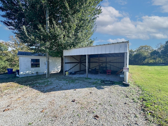 view of outbuilding featuring a lawn