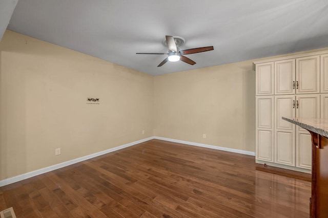 interior space with dark hardwood / wood-style flooring and ceiling fan