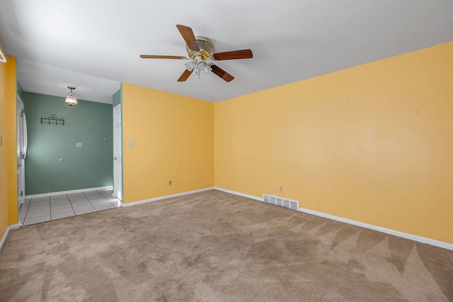 carpeted spare room with ceiling fan