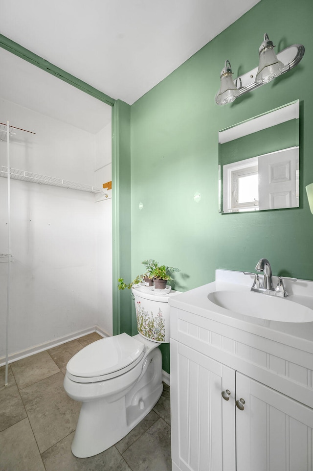 bathroom featuring tile patterned floors, vanity, and toilet