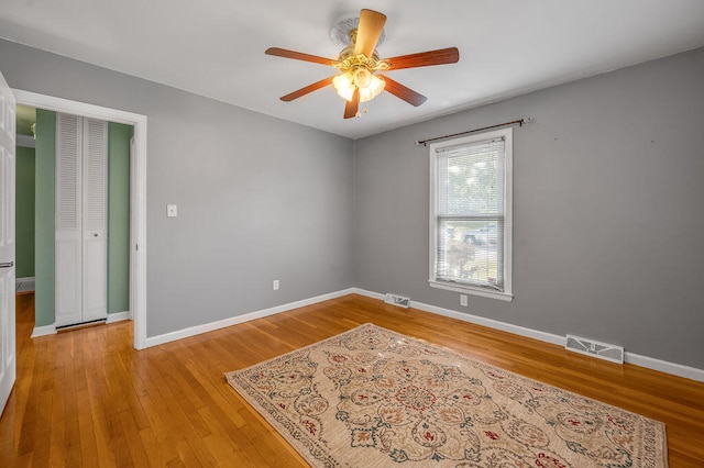 empty room featuring ceiling fan and light hardwood / wood-style flooring