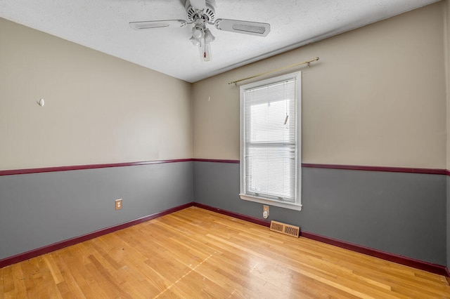 unfurnished room featuring ceiling fan and hardwood / wood-style flooring