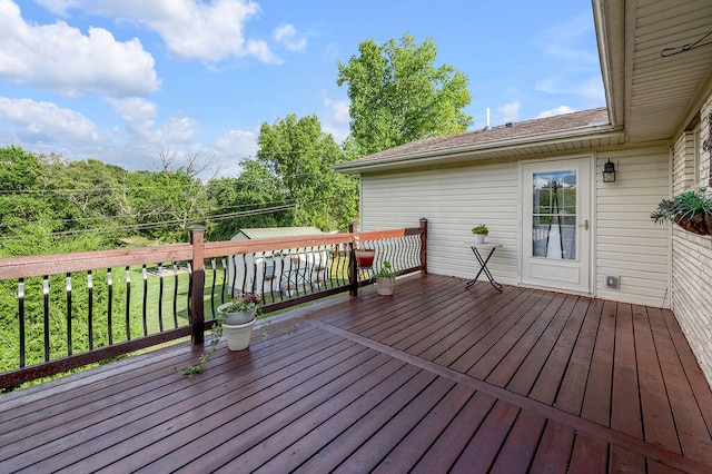 wooden terrace with a yard