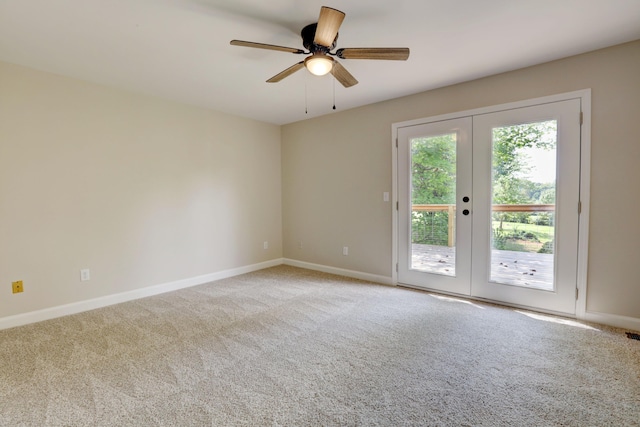 empty room featuring carpet floors, ceiling fan, and french doors