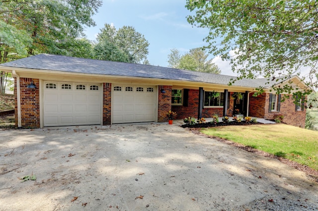 ranch-style house with a garage and a front yard