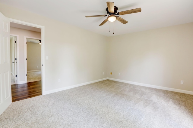 unfurnished room featuring dark colored carpet and ceiling fan