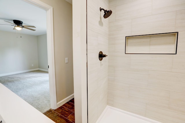 bathroom featuring ceiling fan and tiled shower