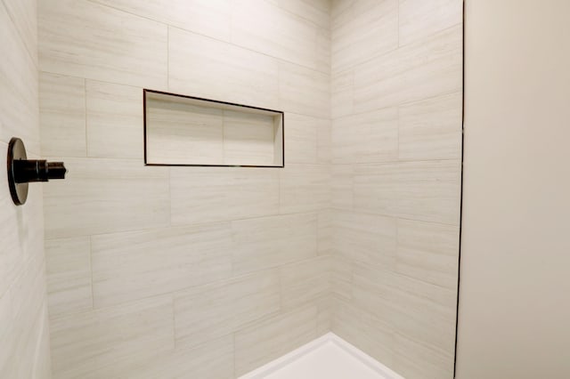 bathroom with tiled shower