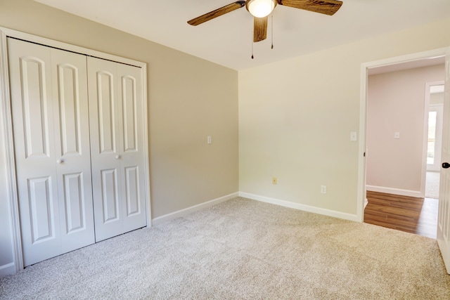 unfurnished bedroom with a closet, ceiling fan, and light colored carpet