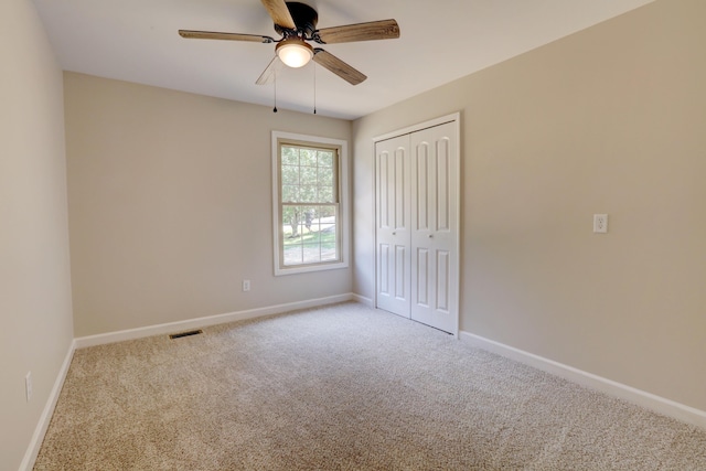 carpeted empty room with ceiling fan