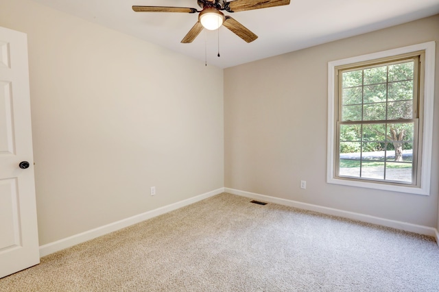 unfurnished room with ceiling fan and light colored carpet