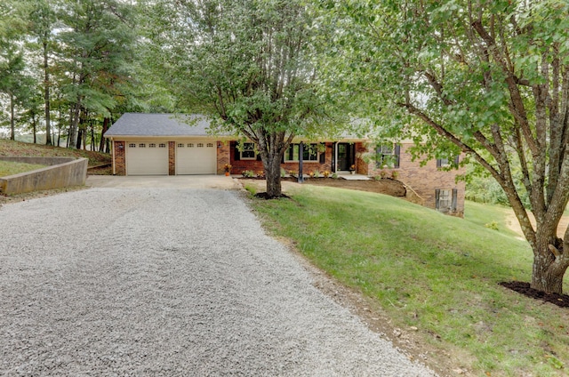 ranch-style house featuring a garage and a front lawn