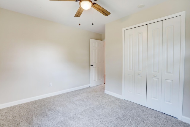 unfurnished bedroom with light carpet, ceiling fan, and a closet