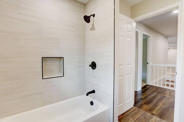 bathroom featuring hardwood / wood-style flooring and tiled shower / bath combo