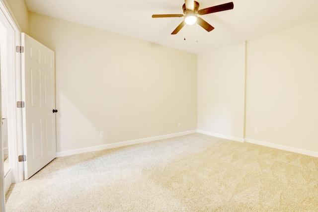 empty room featuring ceiling fan and light colored carpet