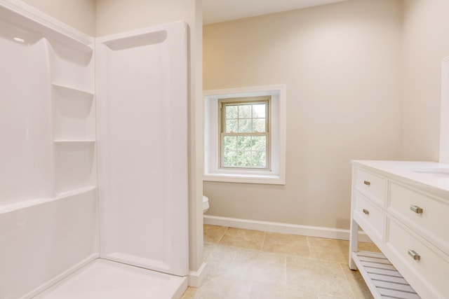 bathroom featuring tile patterned floors, walk in shower, vanity, and toilet