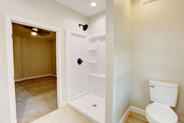 bathroom with walk in shower, tile patterned flooring, toilet, and ceiling fan