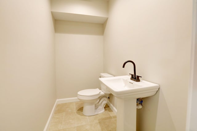 bathroom with tile patterned flooring and toilet